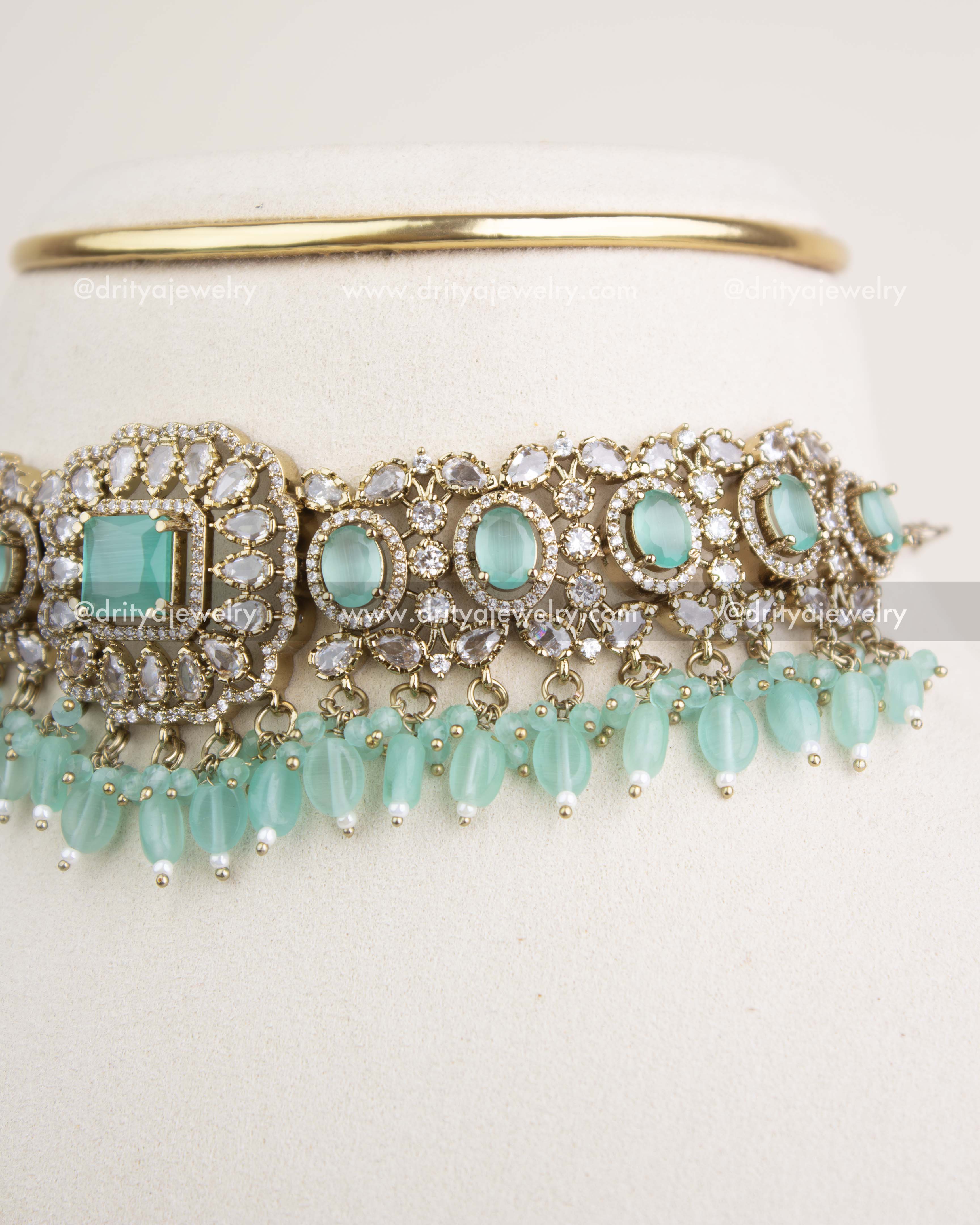 Side angle showcasing mint oval stones, CZ embellishments, and bead hangings.