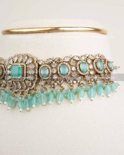 Side angle showcasing mint oval stones, CZ embellishments, and bead hangings.