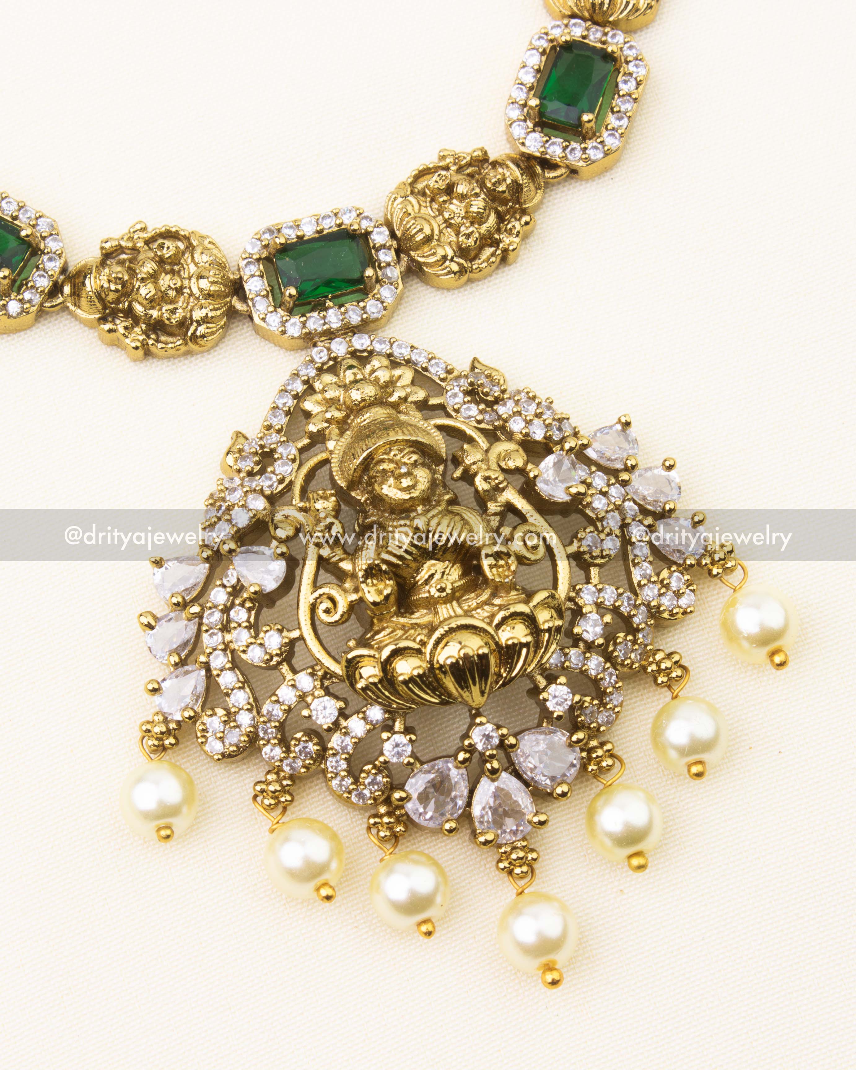 Detailed view of green stone necklace with antique Lakshmi Devi pendant and pearl drops