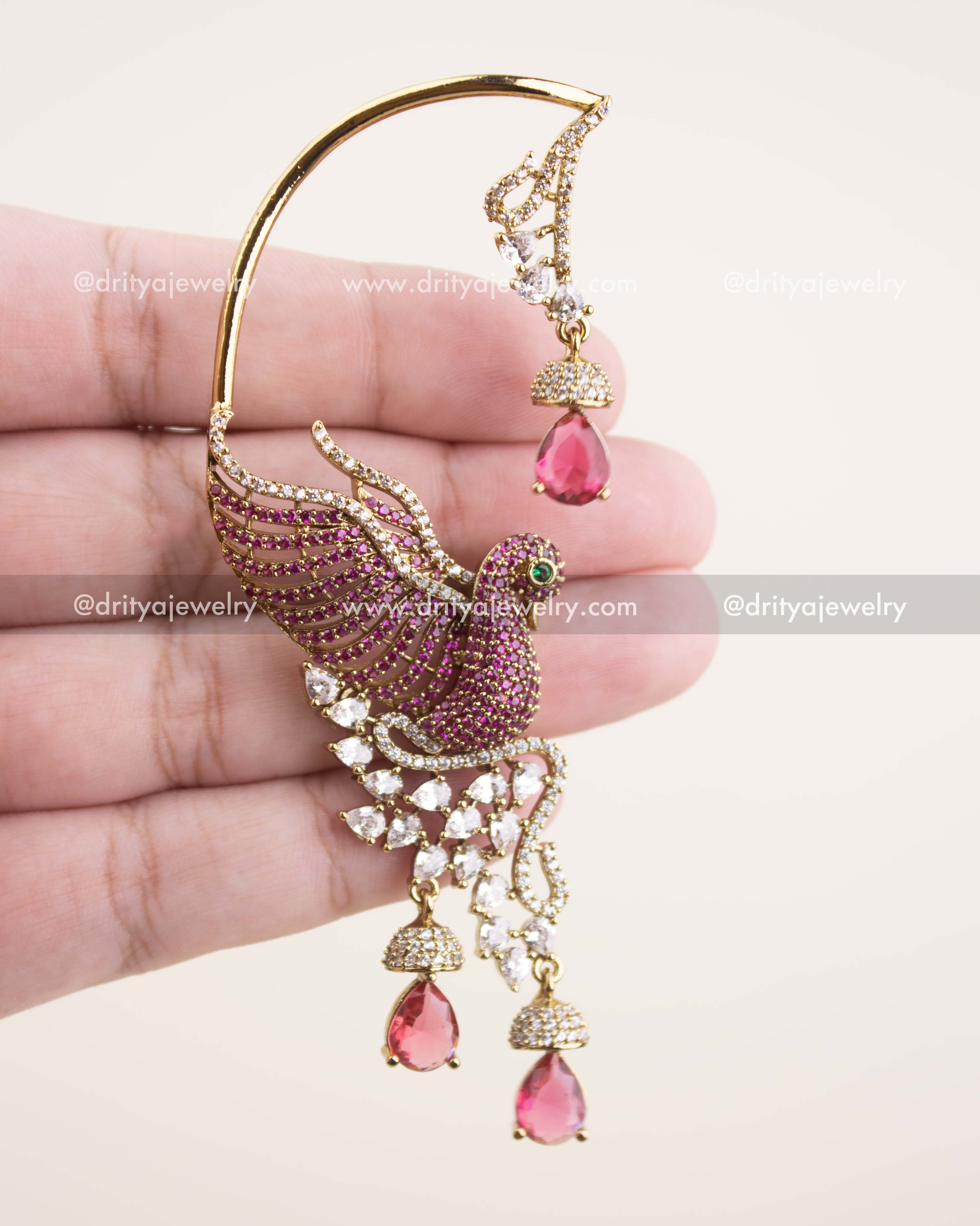 Detailed close-up of Victorian ear cuffs showing CZ stones, feather design, and pink teardrop drops.
