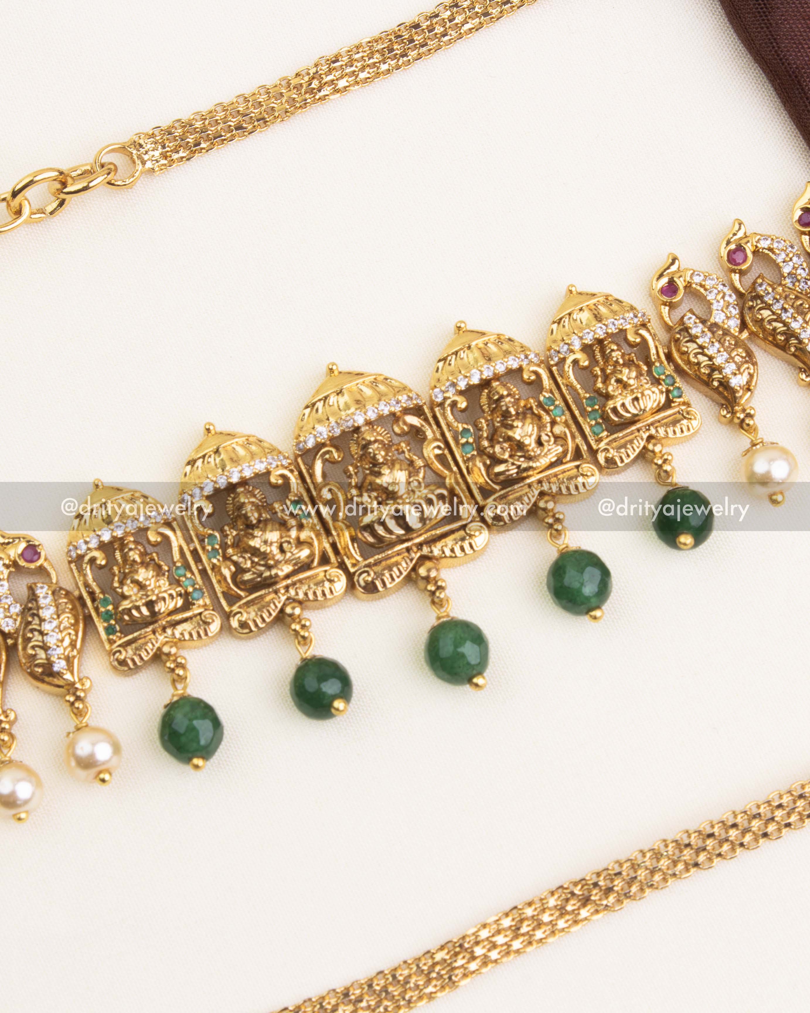 Central design featuring goddess idol with emerald bead drops