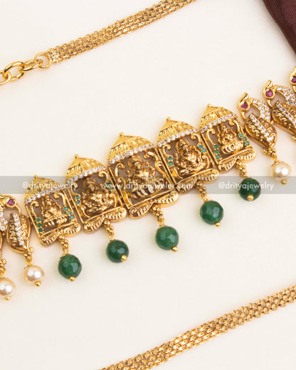 Central design featuring goddess idol with emerald bead drops