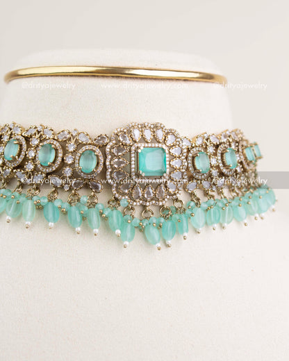 Close-up showing detailed Victorian motifs and mint central stone with CZ work.