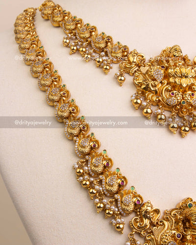 Detailed view of antique peacock motifs on the necklace chain.