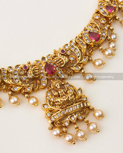 Close-up of Nakshi temple necklace with ruby red stones, CZ detailing and pearl hangings
