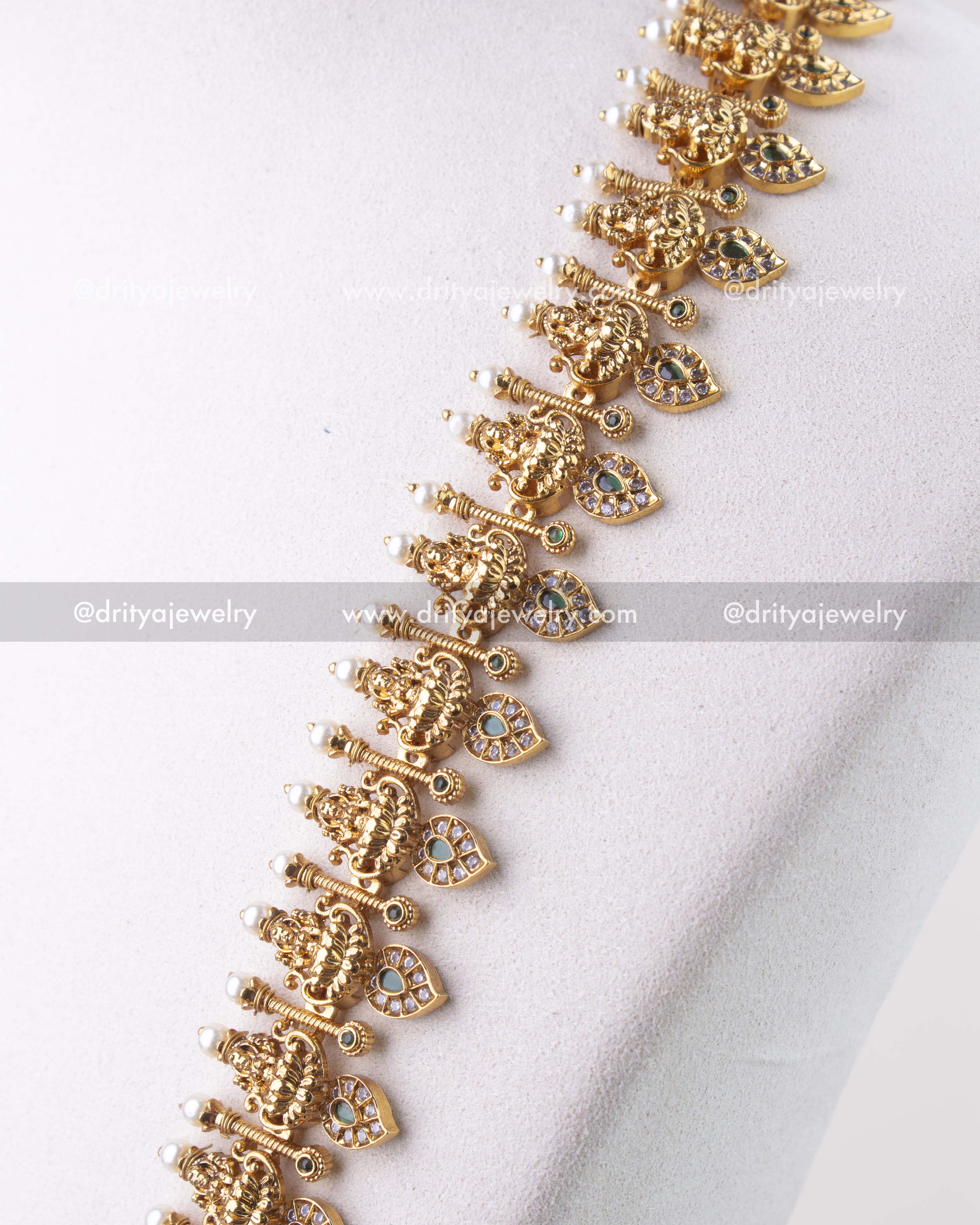1279-G detailed view of layered god idol motifs with pearl-tipped accents on necklace