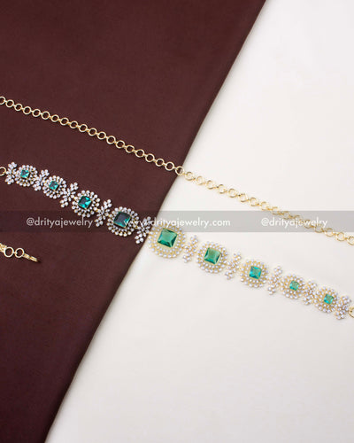 1228-MG premium CZ and Russian emerald waist chain full view on fabric backdrop