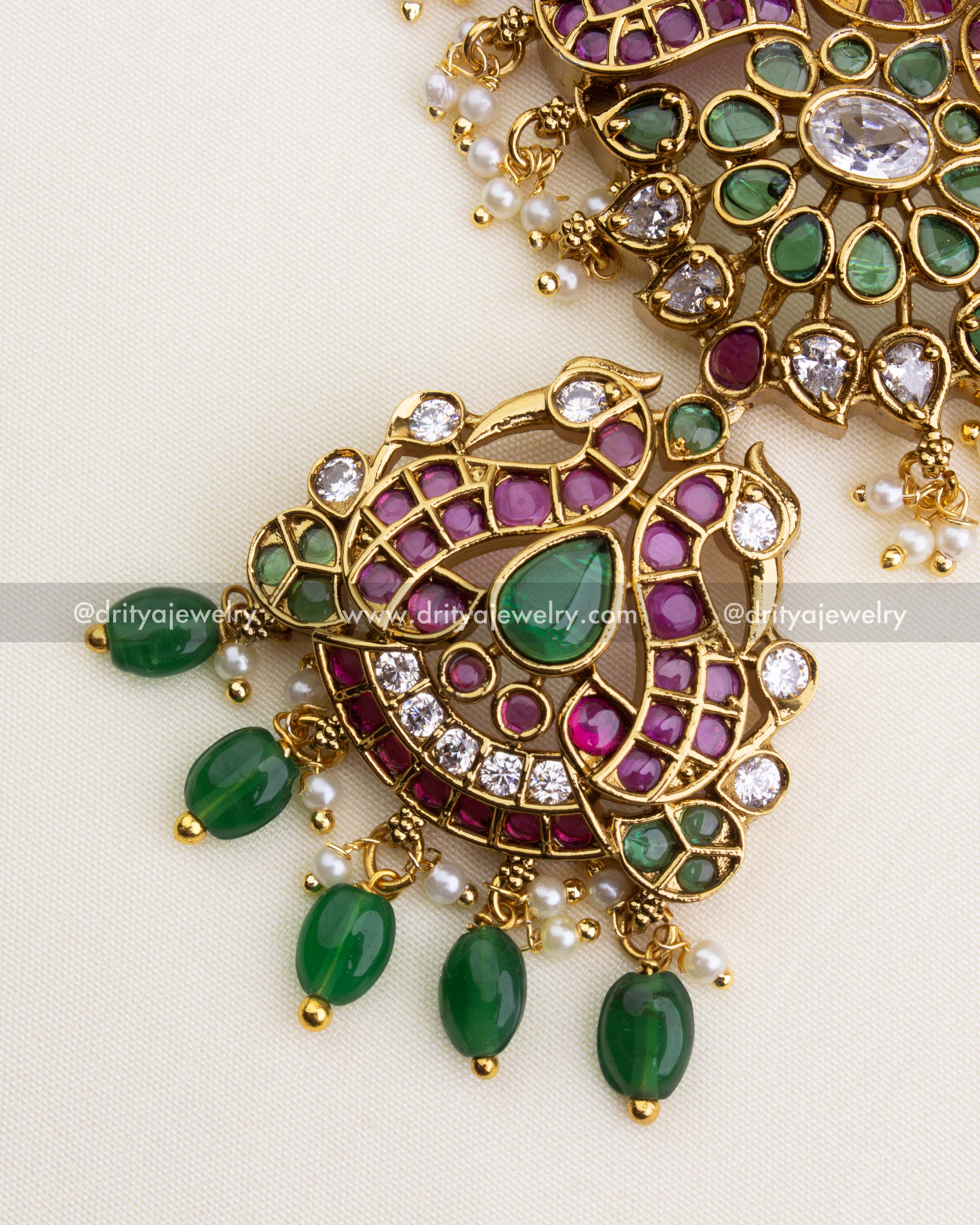 1202 - Pendant detail showing figurine-style butta motif with green drops