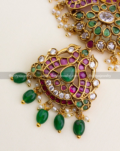 1202 - Pendant detail showing figurine-style butta motif with green drops