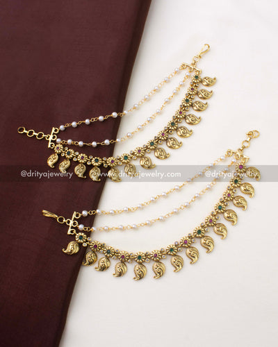 SKU 1294 pair of mango style champaswaralu with layered pearl chains laid on fabric