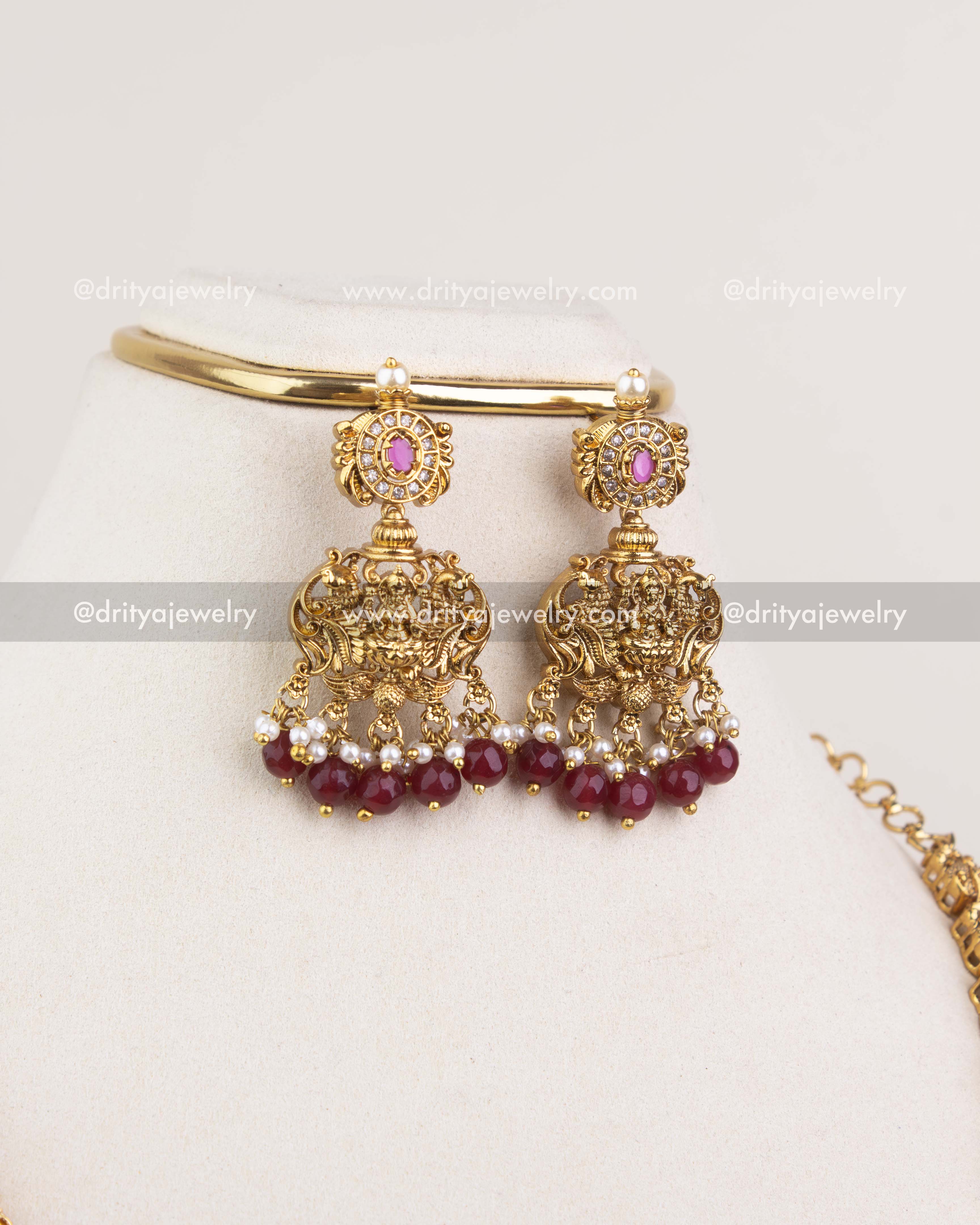 1240-R temple jhumka earrings with ruby bead drops displayed with matching bangle
