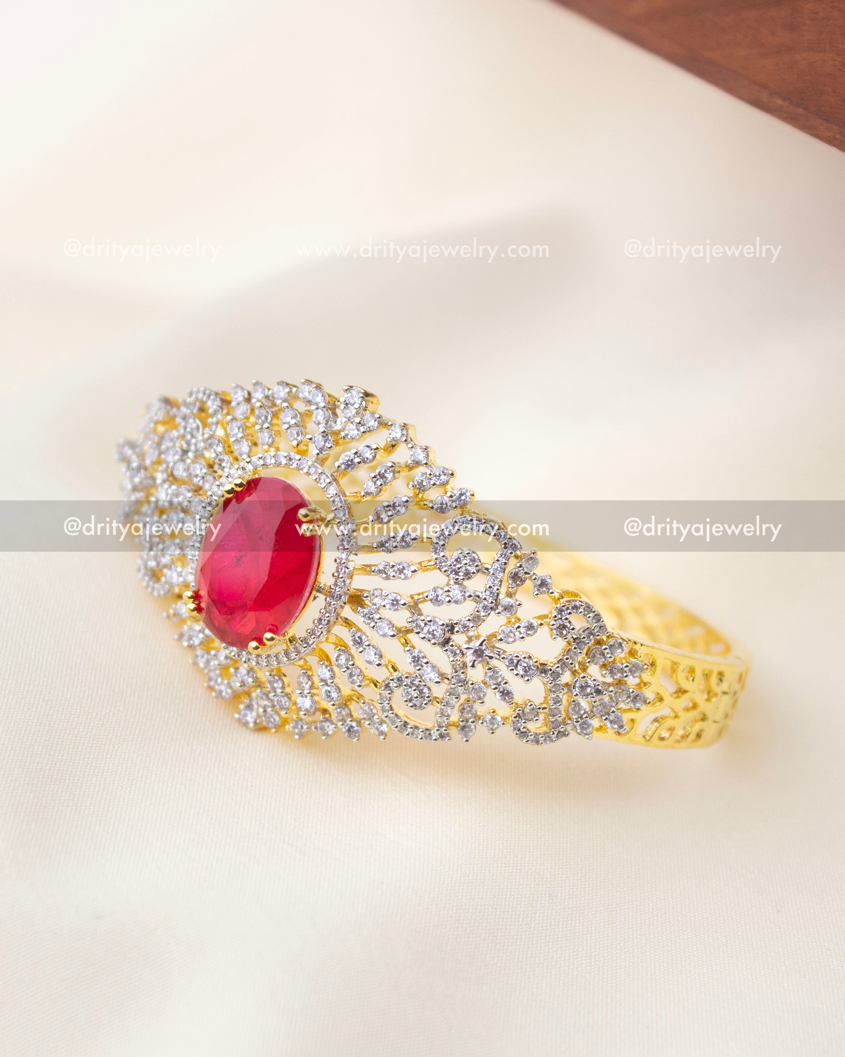 1295-R kada angled view highlighting red center stone and sparkling stones