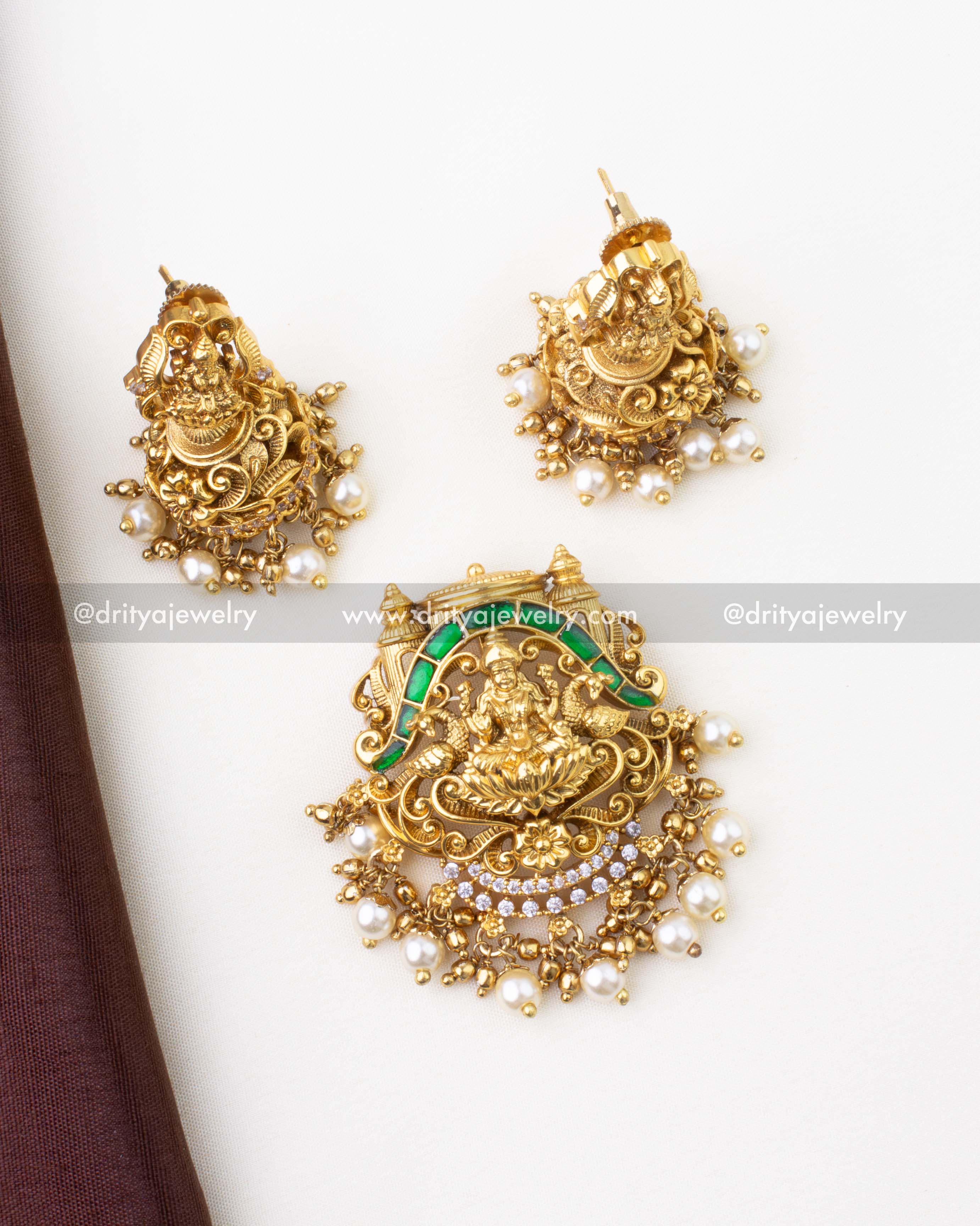 1284-G layered Lakshmi Devi pendant with matching jhumka earrings set laid flat
