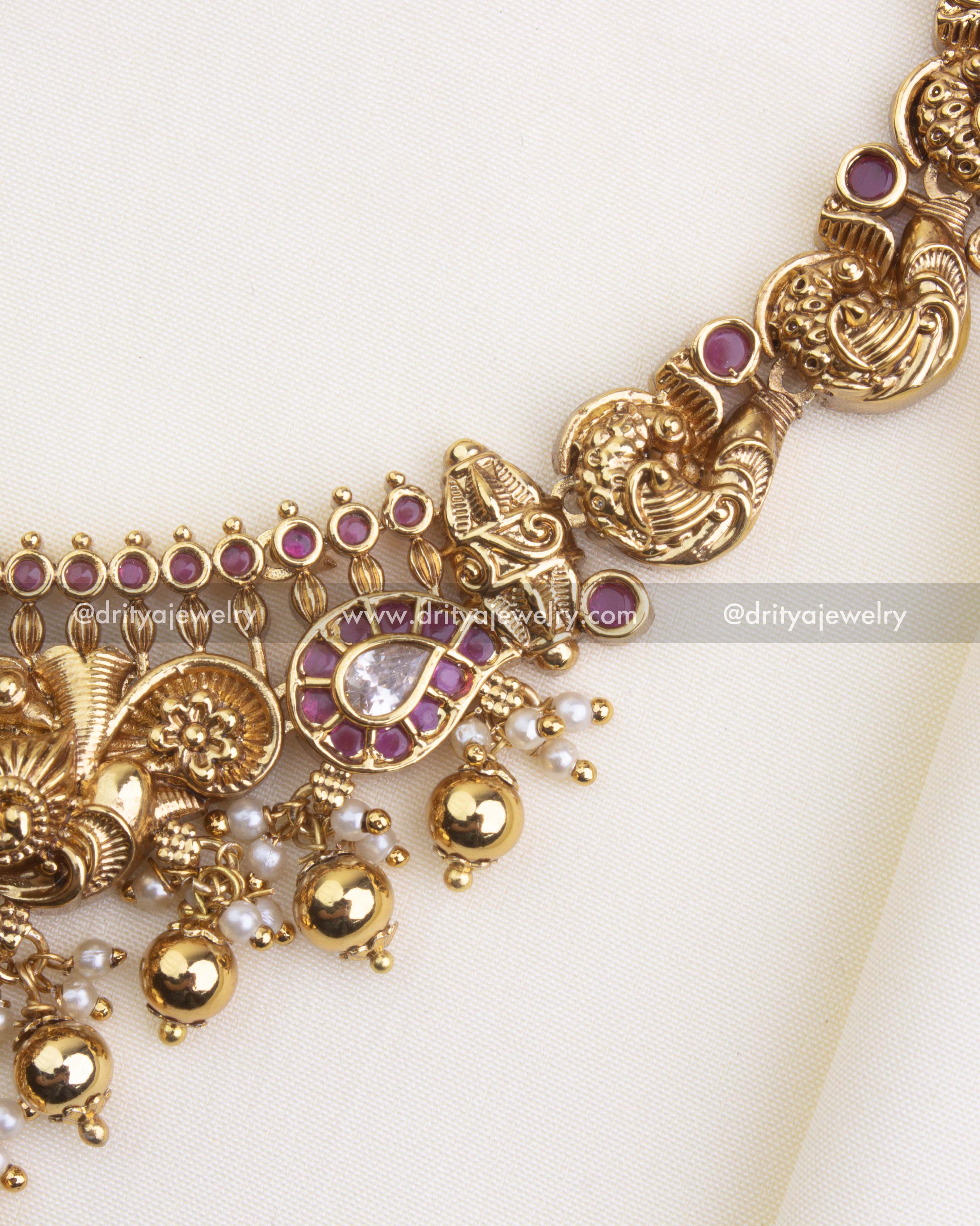 SKU 1105 Necklace Set - Side detail view of nakshi peacock links and stone-studded drops on the short necklace