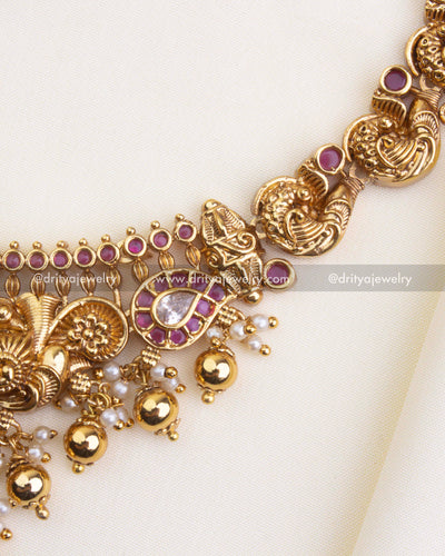 SKU 1105 Necklace Set - Side detail view of nakshi peacock links and stone-studded drops on the short necklace