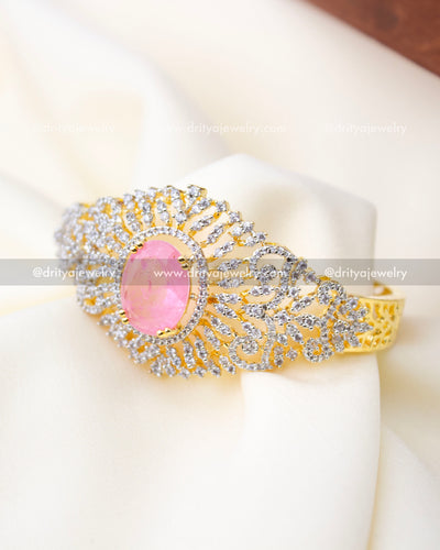 Front angled view of premium kada with crackled pink center stone and halo of sparkling stones, SKU 1295-BP