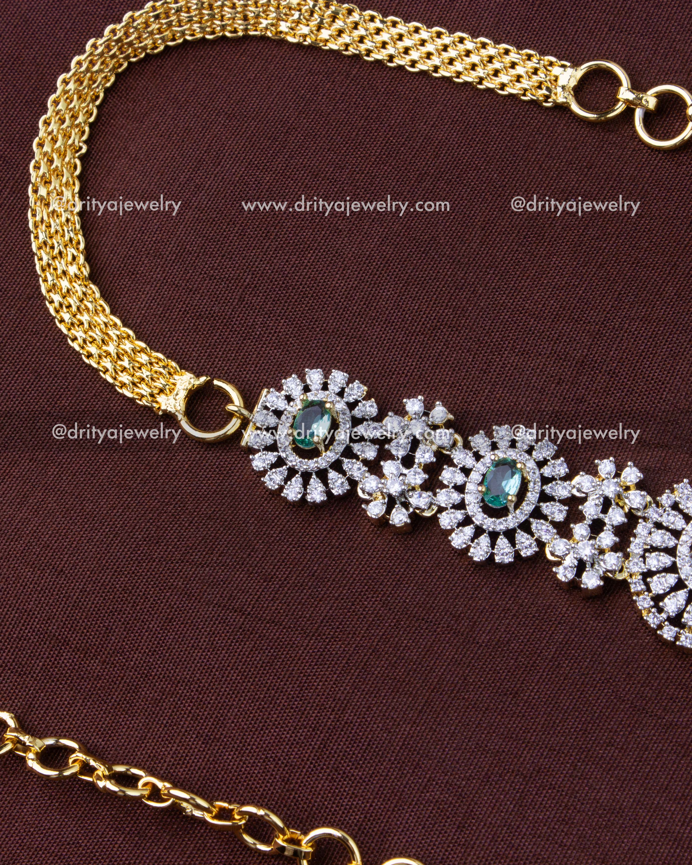 1291-RE hip chain showing central emerald CZ panel and gold-toned side chains