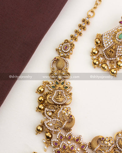 SKU 1252 - Side view of temple necklace link detailing with deity and peacock motifs