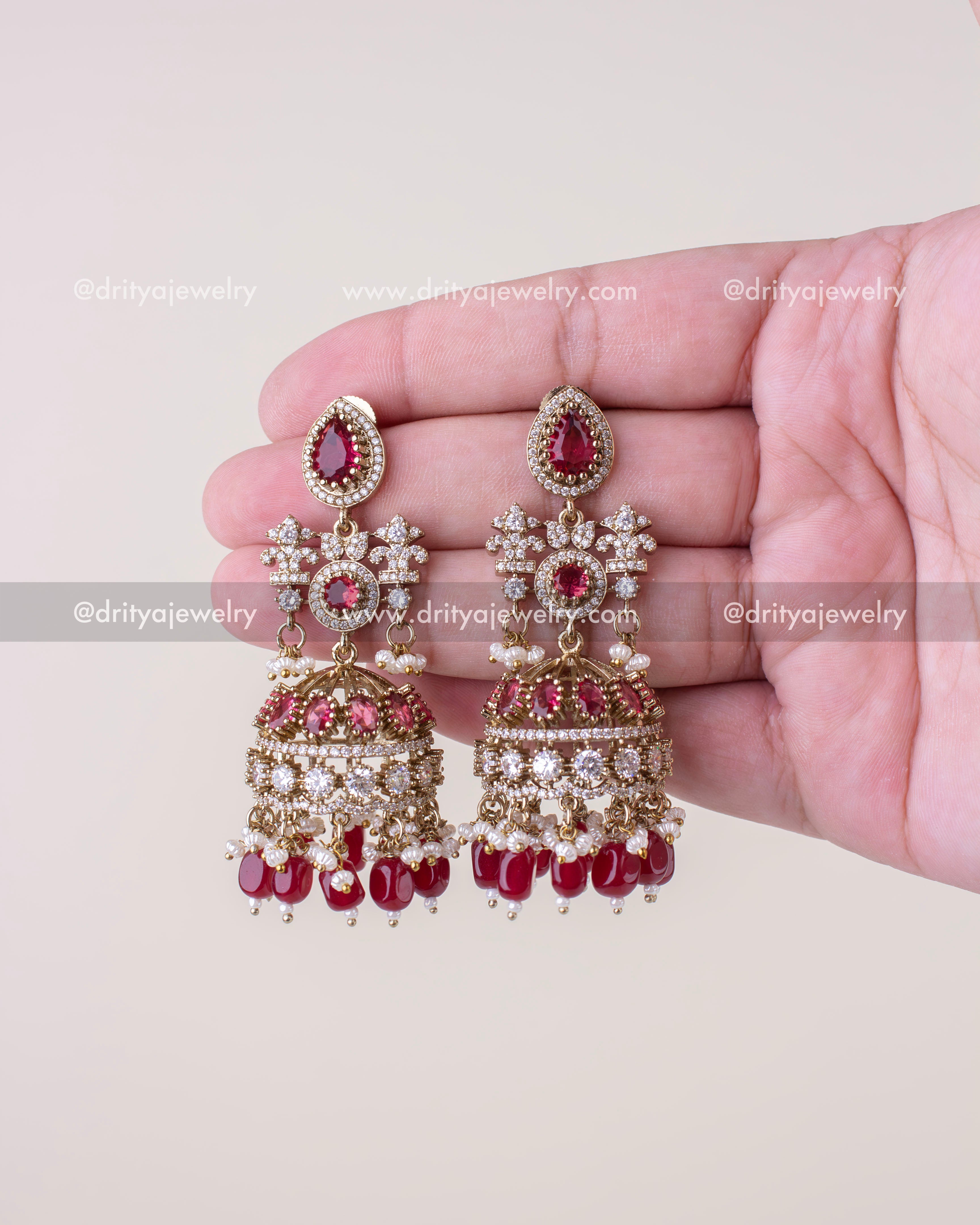 1257-R pair of Victorian red bridal jhumka earrings front view in hand