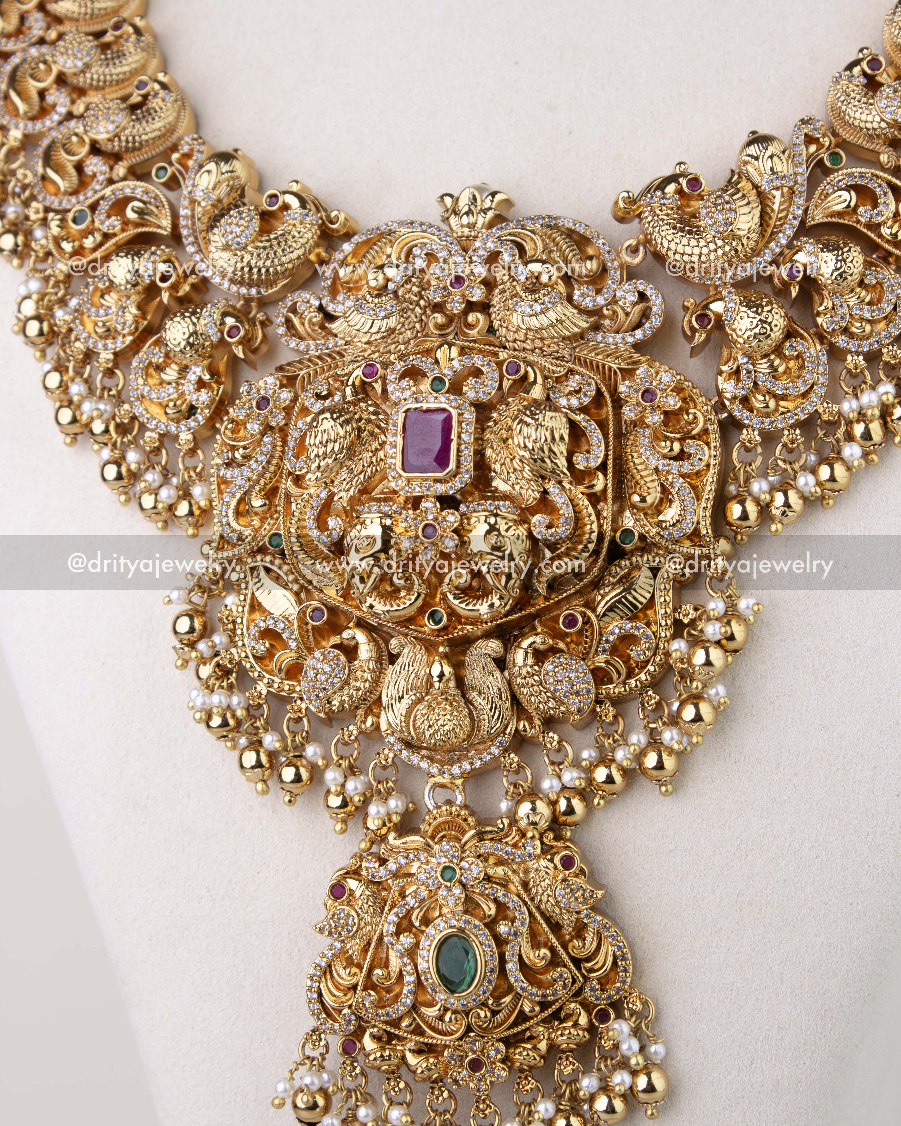 1310 - Central pendant of premium bridal long haram with layered figurine motifs and stone accents
