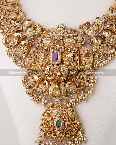 1310 - Central pendant of premium bridal long haram with layered figurine motifs and stone accents