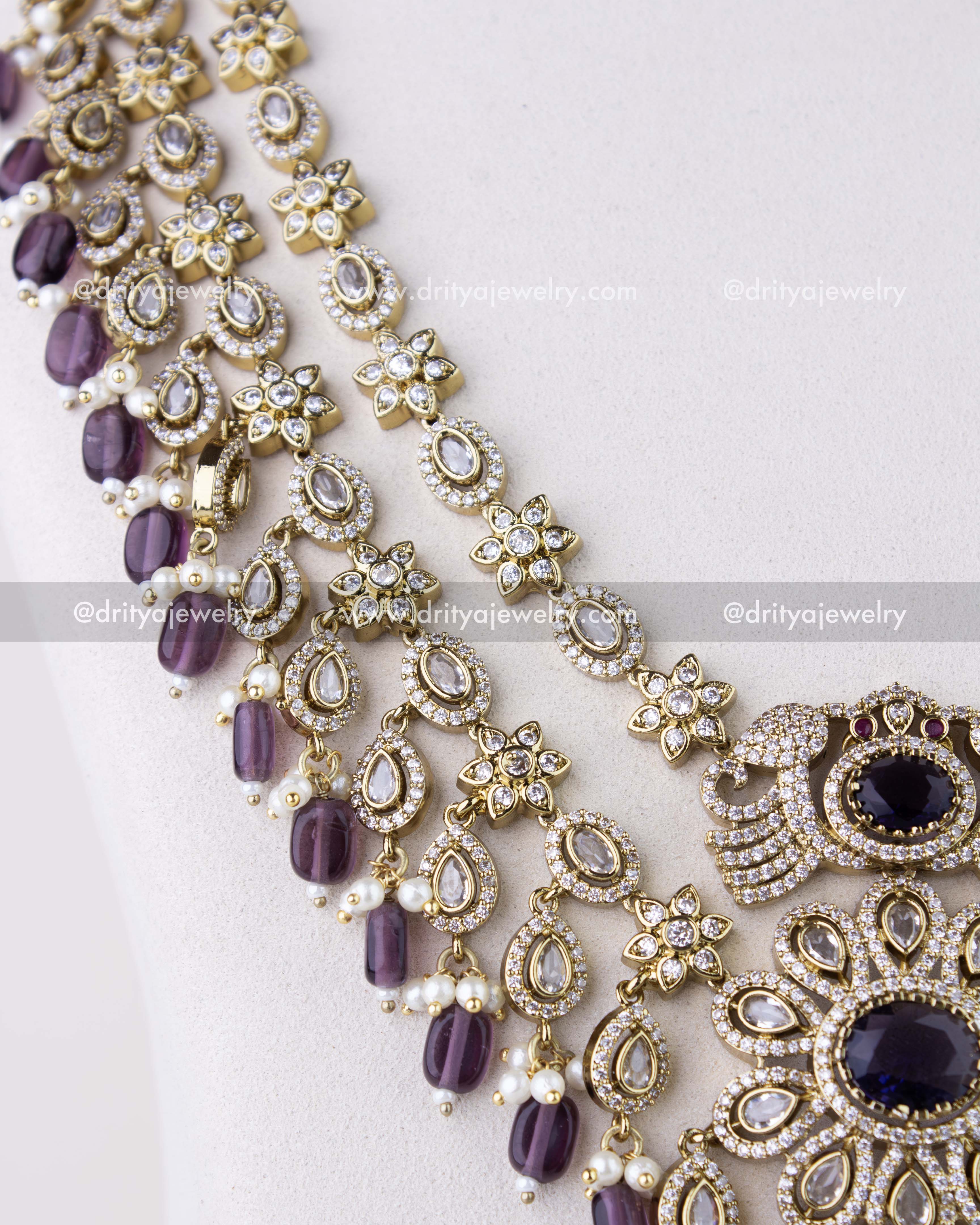 1309-PUSET close-up of necklace strands with teardrop CZ motifs and purple bead drops