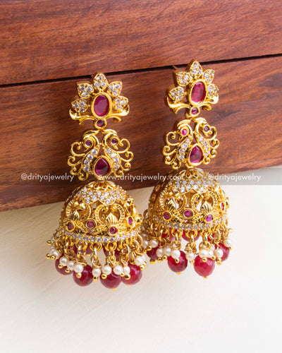 844-R - Earrings - Close front angle view of antique gold jhumka earrings with ruby stones and pearl drops