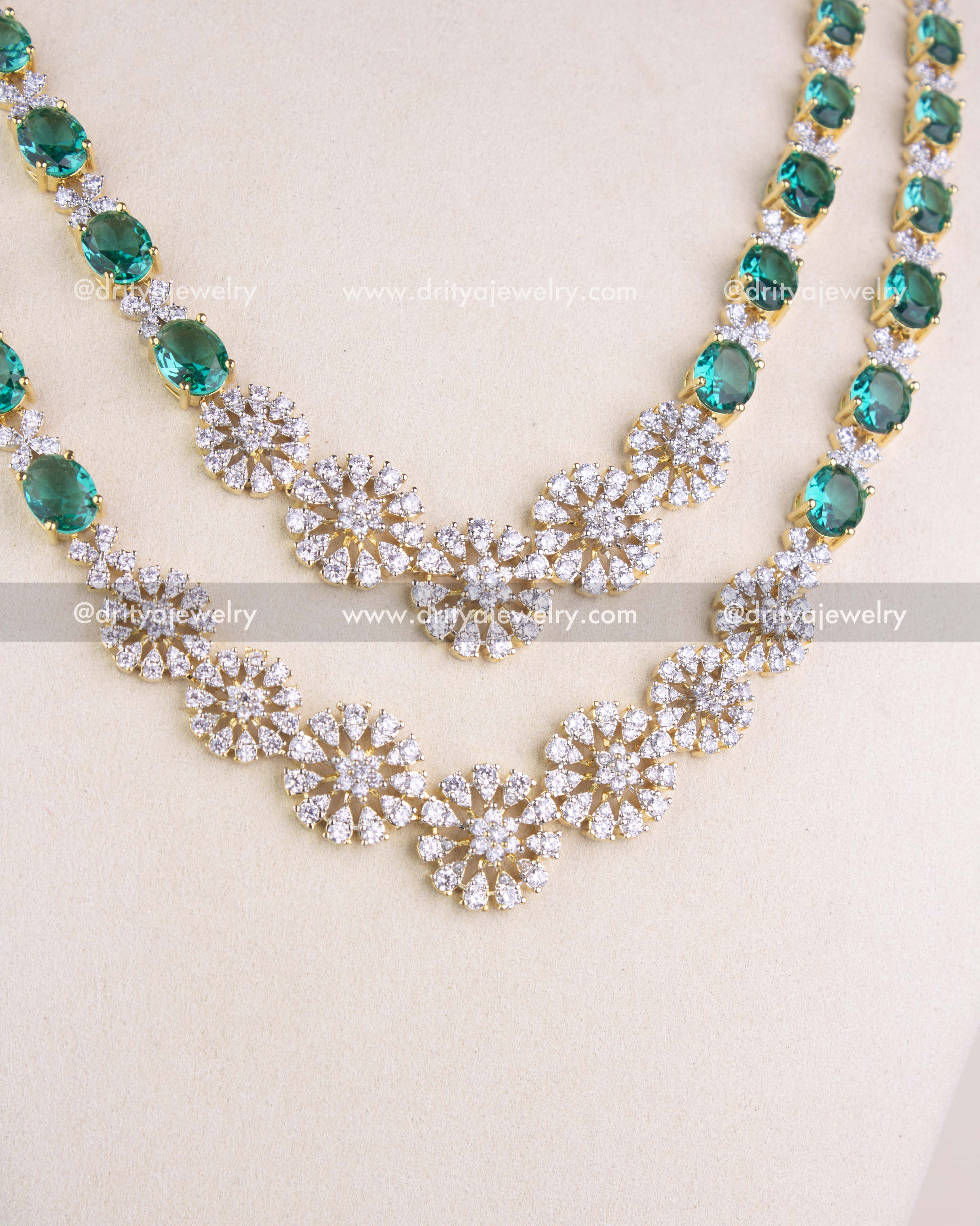1215-RE close-up of dual-layer CZ floral necklace detailing with emerald accents