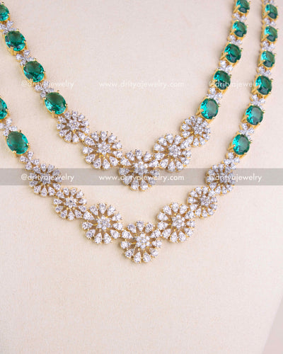 1215-RE close-up of dual-layer CZ floral necklace detailing with emerald accents