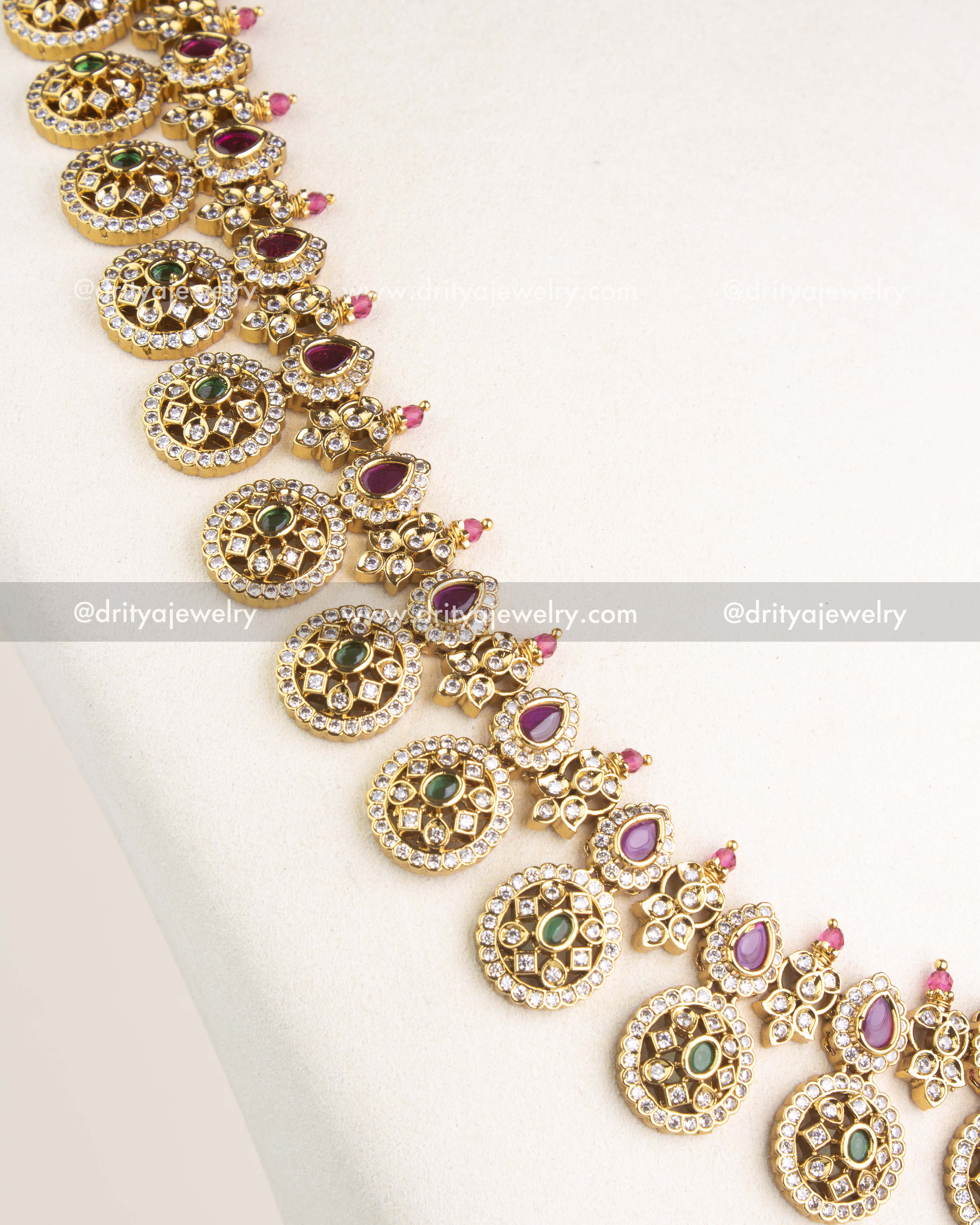 SKU 1153 Necklace Set angled view highlighting repeating bottu motifs and ruby-toned pear stones