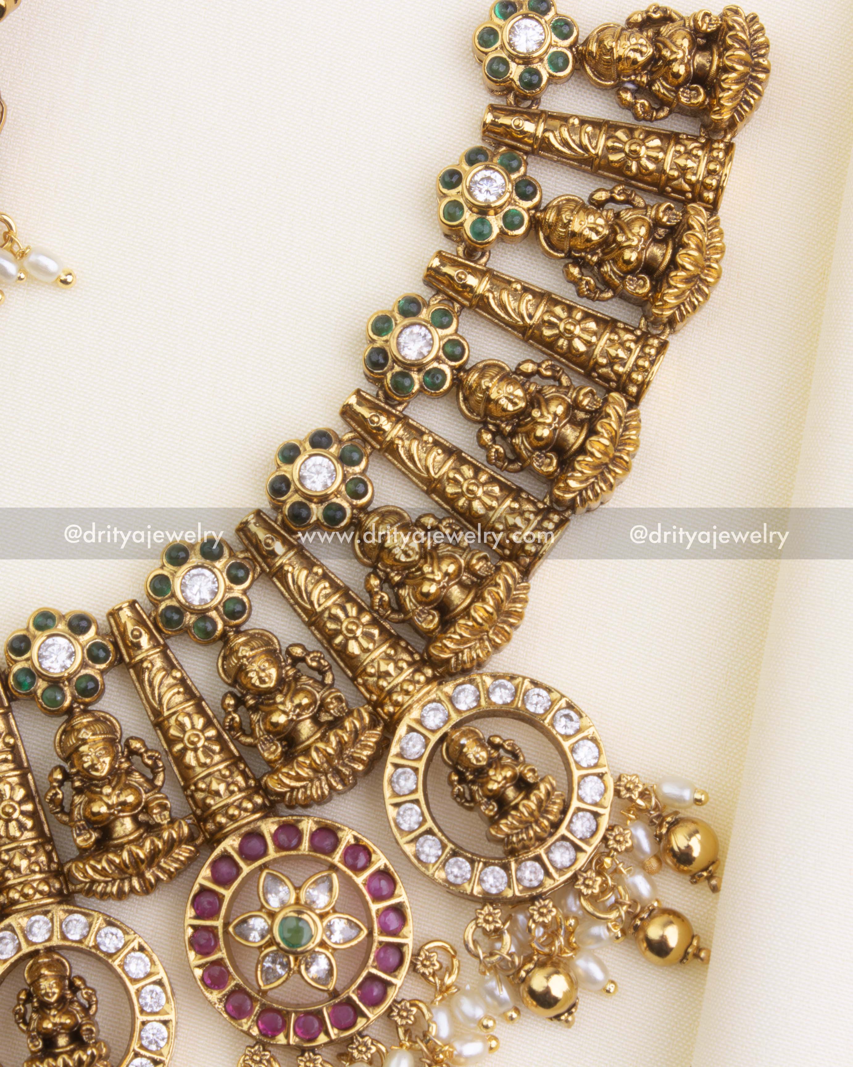 1194 - Side angle of antique gold temple necklace with idol motifs and stone clusters