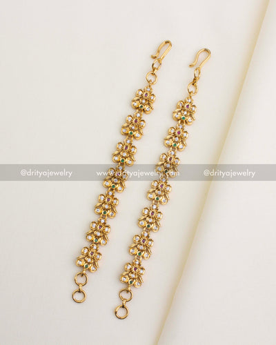 SKU 1146 antique floral CZ maang tikka pair full view laid flat on fabric