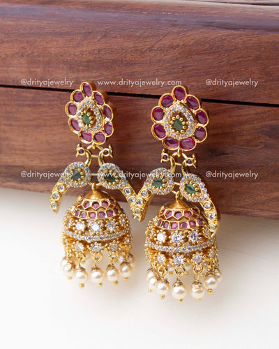 1300 - Side angle view of premium peacock design CZ jhumka earrings with pearl drops