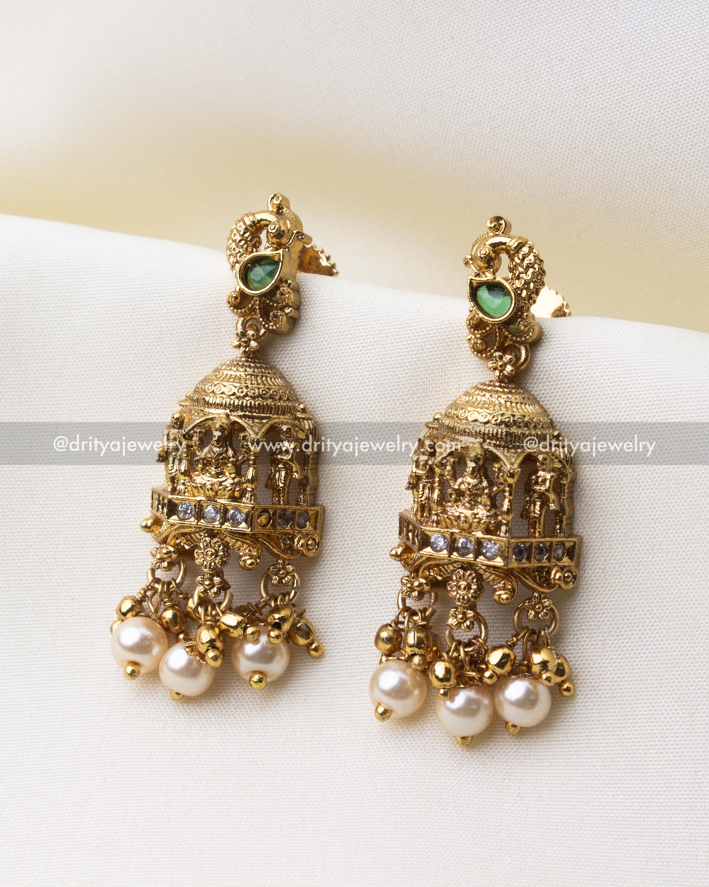 1219-G temple-style gold-toned god idol dangler earrings with peacock studs and pearl-like drops front view