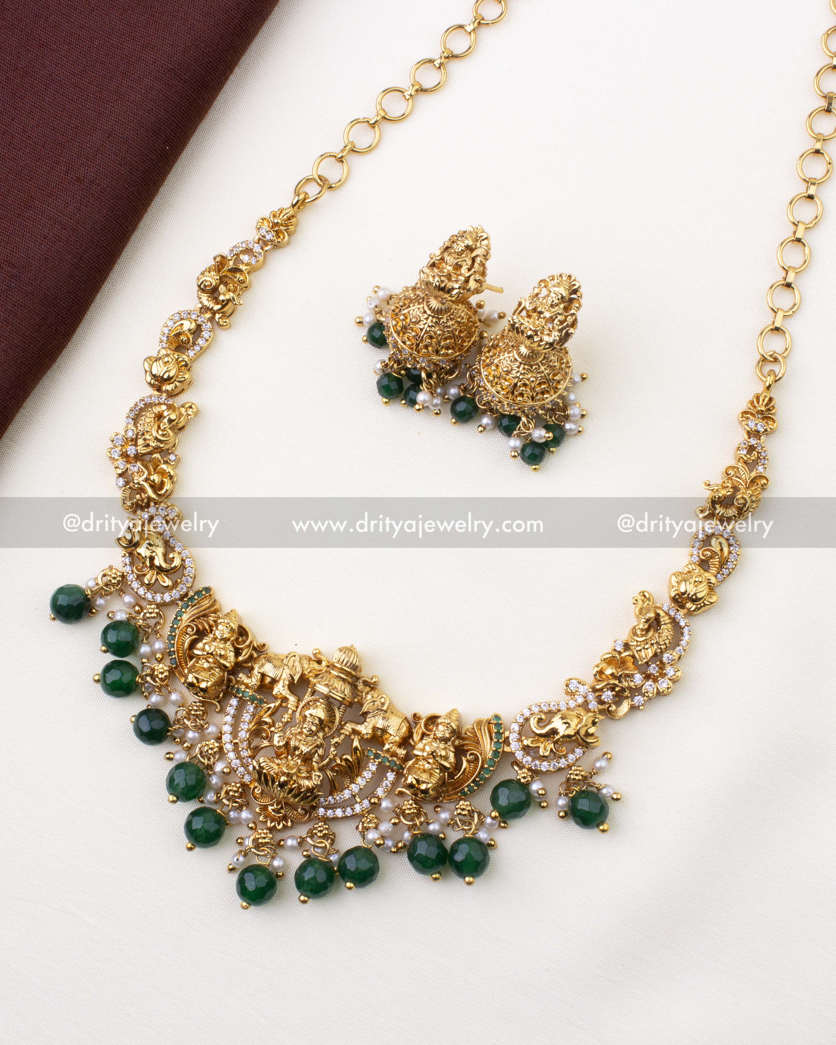 1101-G temple short necklace set with Lakshmi pendant and matching jhumkas laid flat