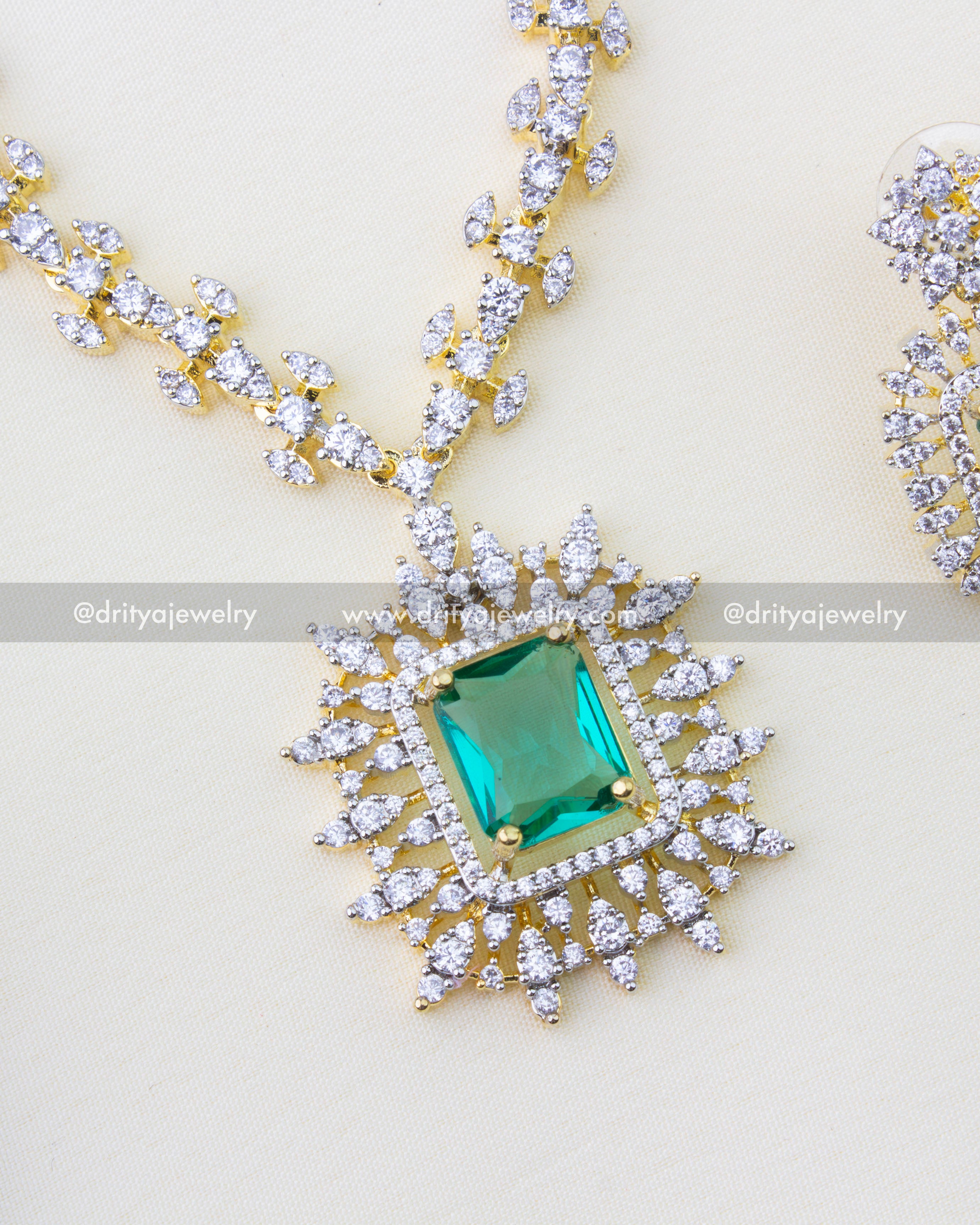 1276-RE close-up of emerald pendant with diamond replica halo on chain