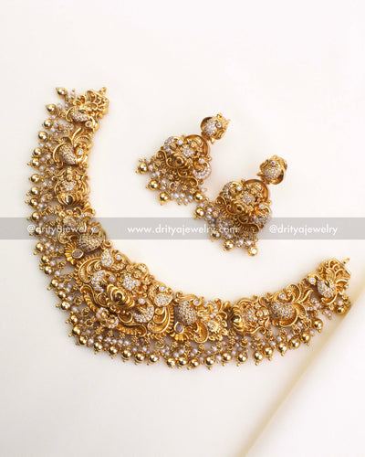 700-W - Necklace Set - Full short necklace with matching god idol earrings laid flat on fabric