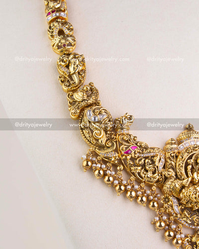1238 - Close-up of sculpted motifs and bead fringe on temple necklace