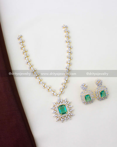 1276-RE premium emerald necklace set with matching earrings laid flat