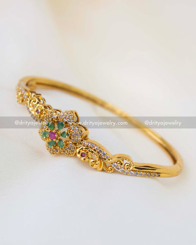 SKU 1256 side angle of stone-studded floral kada bangle with intricate detailing
