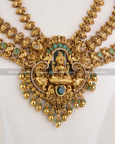 Close-up of long temple necklace pendant with Lakshmi idol and green stone detailing 1244-SET