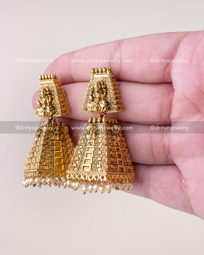 Pair of temple gopuram jhumka earrings showing side profile and pearl fringe