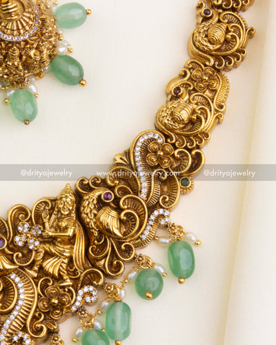 1195 - Detailed view of figurine motifs and peacock design on necklace