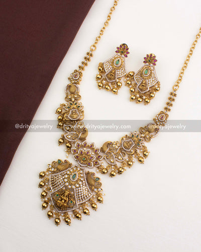 SKU 1252 - Complete temple short necklace set with matching earrings laid flat