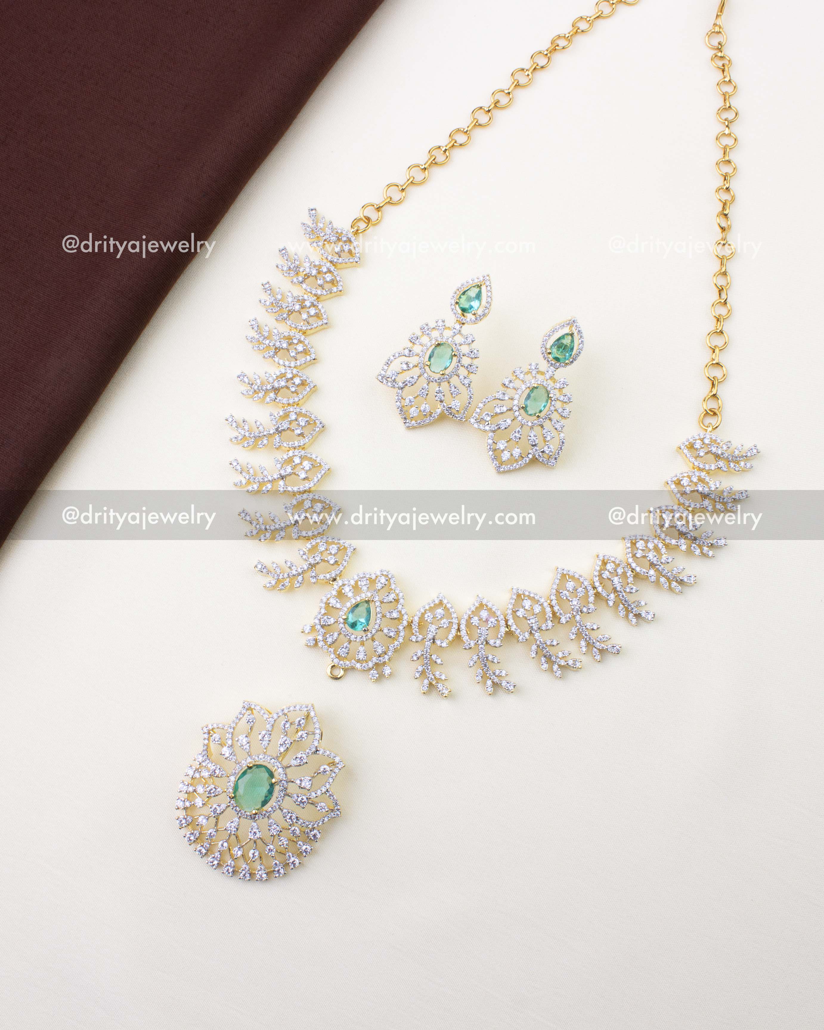 1232-RE premium diamond replica necklace set with detachable green stone pendant and earrings laid flat