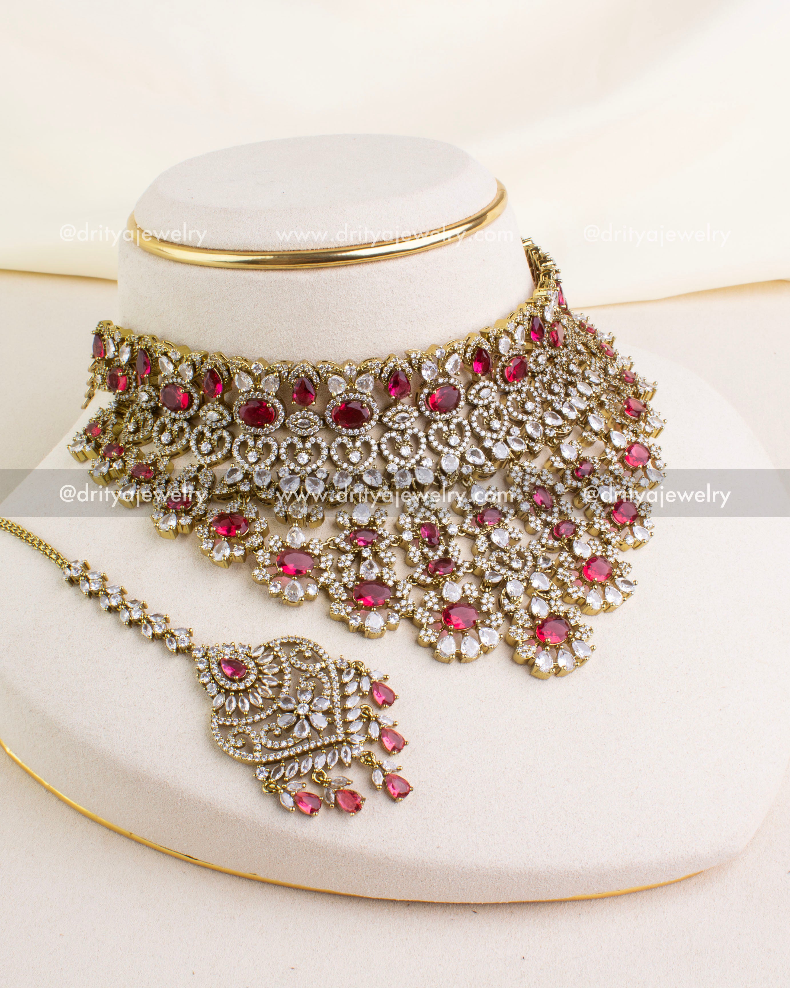 1043-R premium Victorian red stone choker necklace set with maang tikka displayed on stand