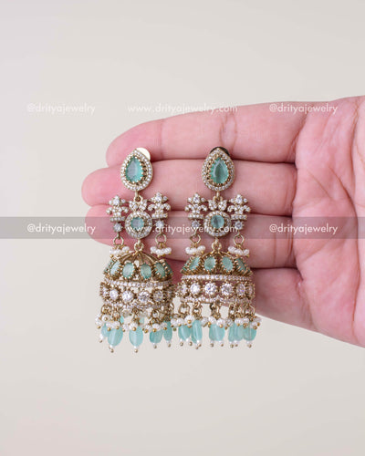 1257-MG - Full front view of mint stone Victorian bridal jhumka earrings held in hand
