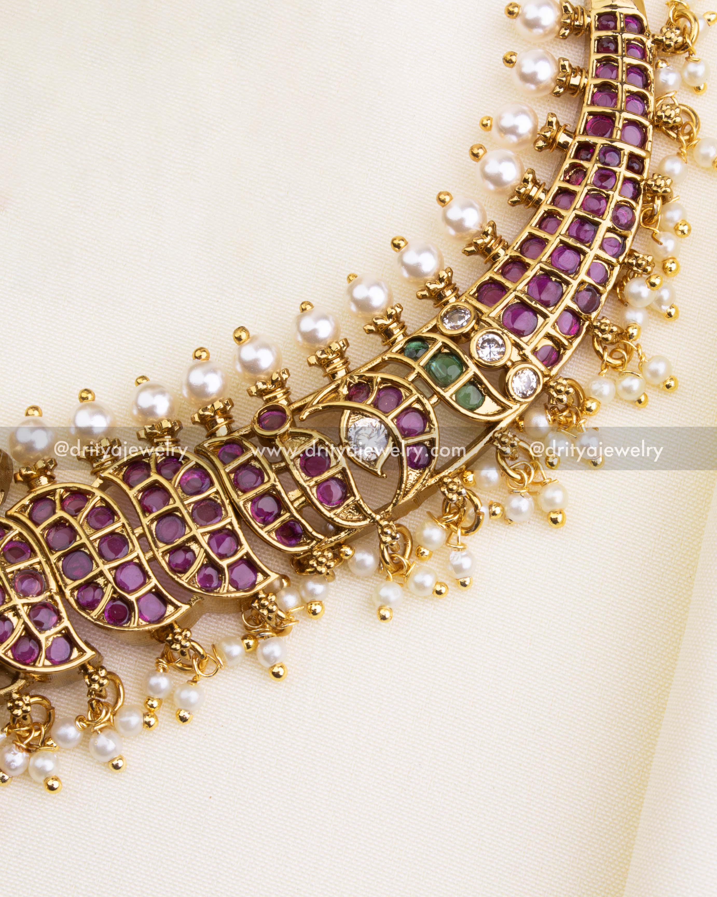 1202 - Close-up of short necklace band with ruby stones and pearl edging