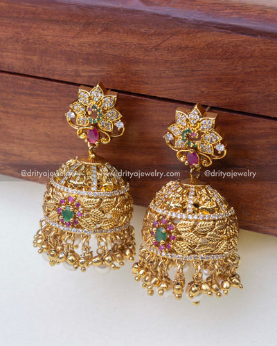 1241-GO big temple jhumka earrings angled view showing leaf design and pearls