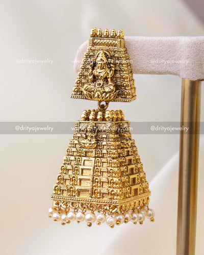 Single antique gold temple gopuram god idol jhumka earring with pearl drops close-up